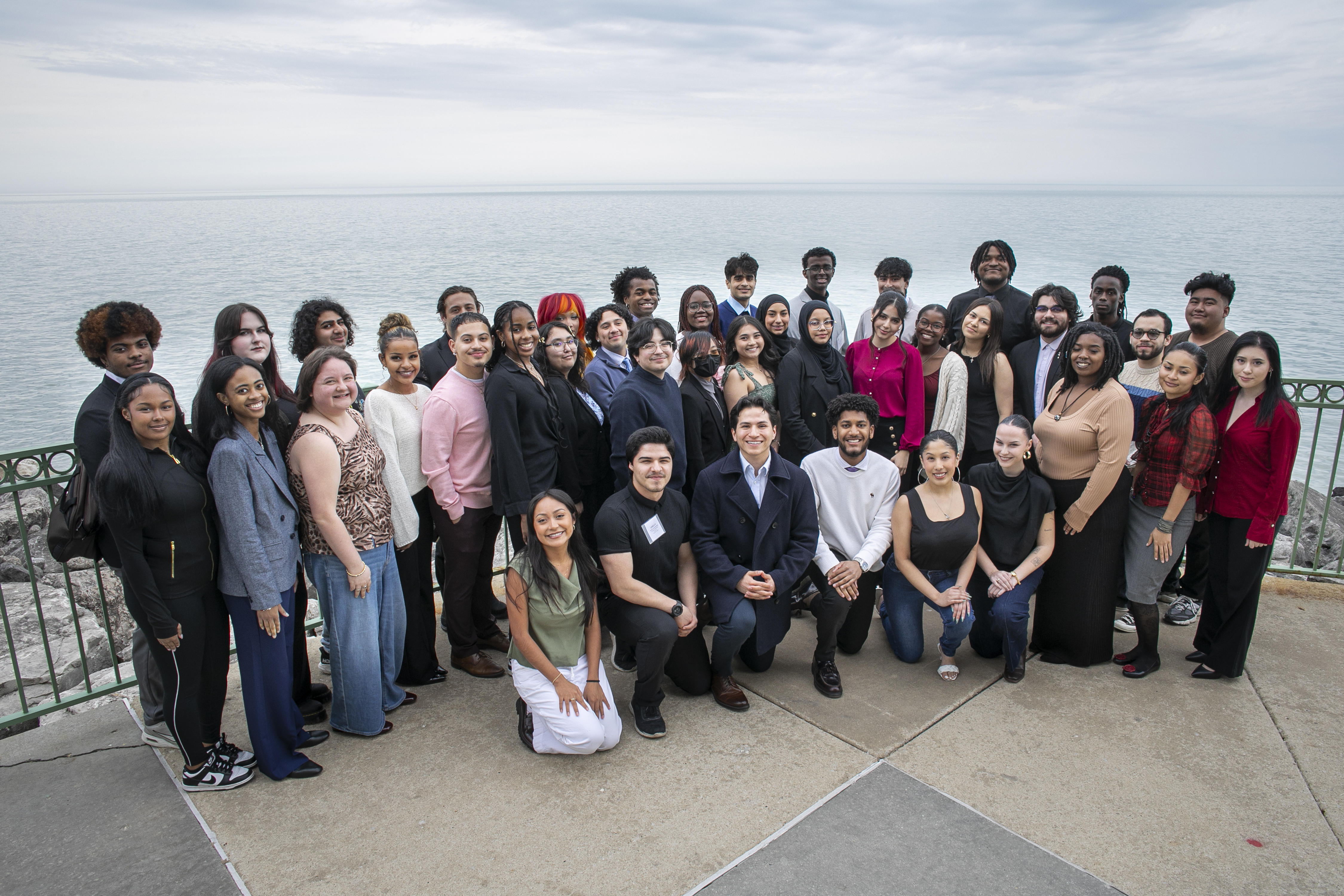 Loyola University Chicago's Leadership Scholars Programs students pose smiling for a photo during an End of Year Celebration event. The group is dressed in semi-formal attire.